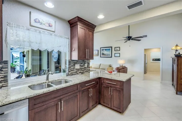 Kitchen, tasteful backsplash, dishwasher, light tile flooring, and sink