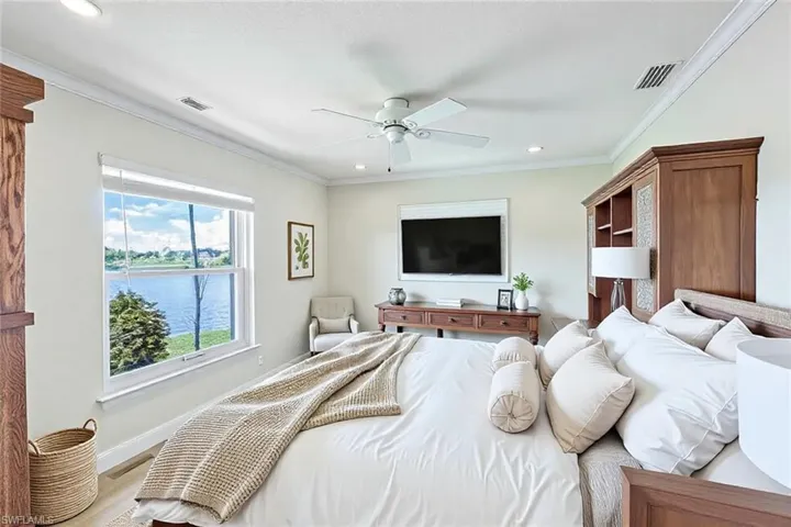 Bedroom with visible vents and crown molding