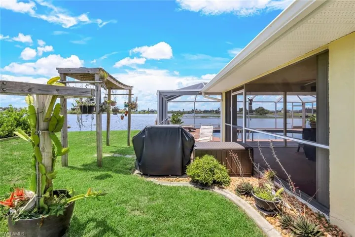View of yard with a boat dock and a water view
