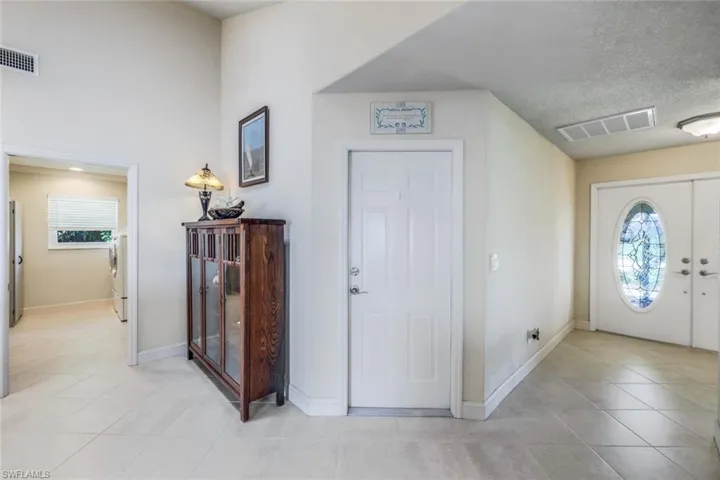 Entryway featuring a healthy amount of sunlight and light tile flooring.