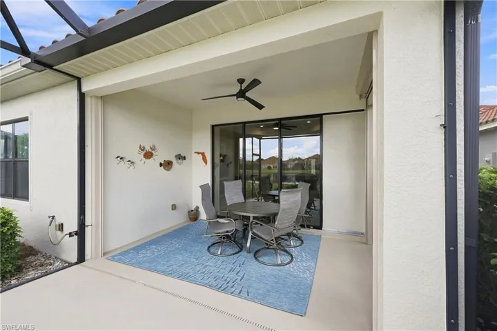 Covered patio featuring a ceiling fan and concrete flooring