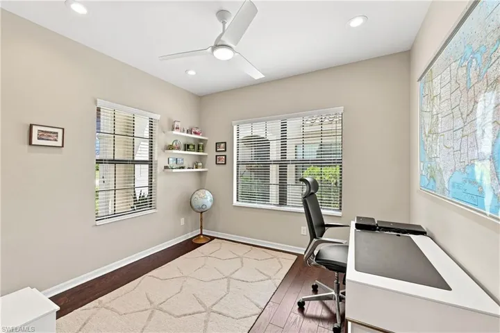 Recessed lighting, ceiling fan, wood-finish flooring, multiple windows with blinds, and built-in shelving