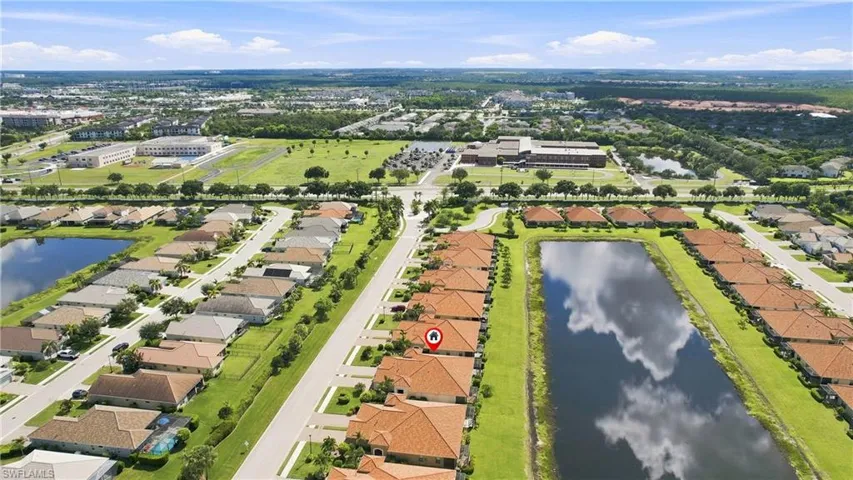 Aerial perspective showcasing a residential community with water features and mature landscaping