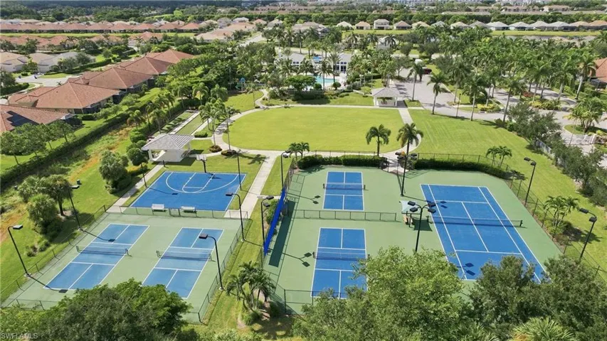 Community amenities featuring multiple tennis courts, pickleball courts, a basketball court, and a large green space