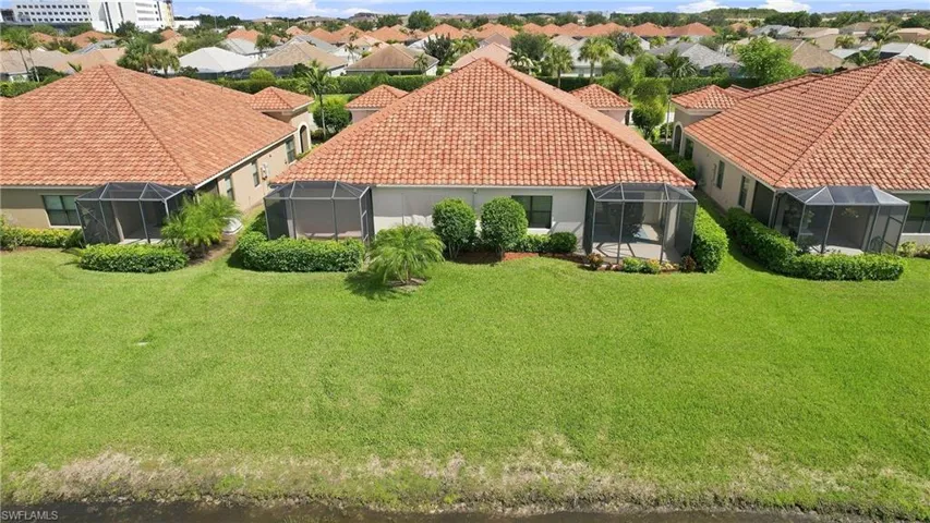 Expansive green space featuring two screened-in patios and terracotta-style roof tiles