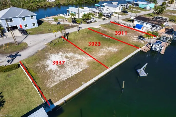 Birds eye view of property with a water view
