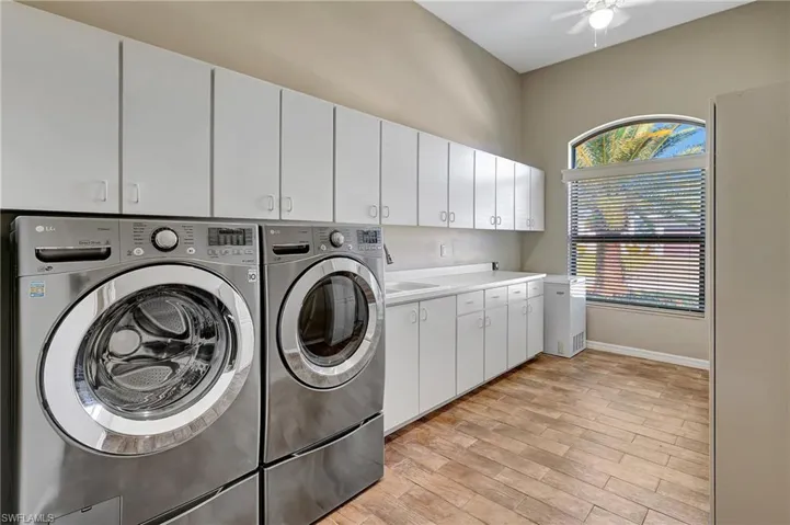 This laundry room is massive with tons of storage.