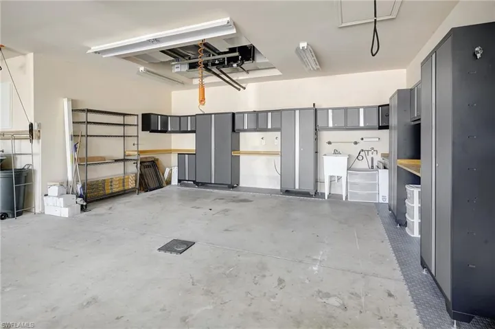 Garage is plumbed with air compressor fixtures and hose so you can access compressed air. Plenty of storage and work space too!