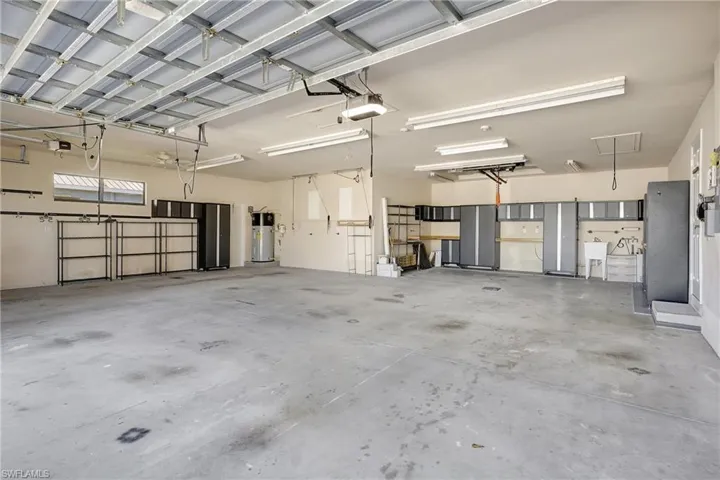 Garage is plumbed with air compressor fixtures and hose so you can access compressed air. Plenty of storage and work space too!