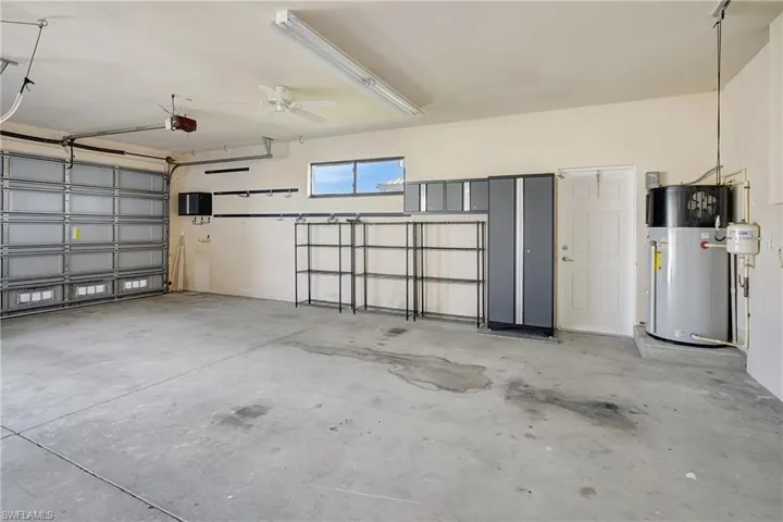 Garage is plumbed with air compressor fixtures and hose so you can access compressed air. Plenty of storage and work space too!