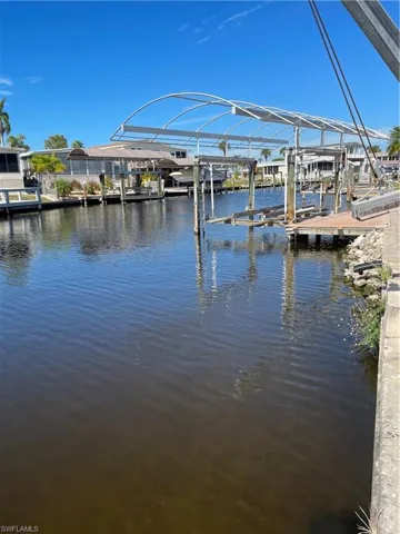 Dock with boat lift and a water view