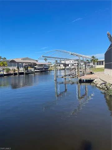 Dock with boat lift and a water view