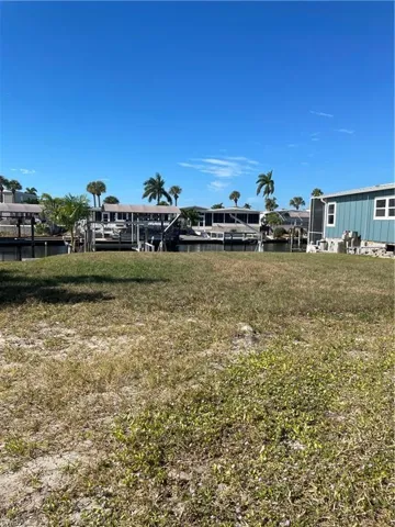 View of grassy yard with a water view