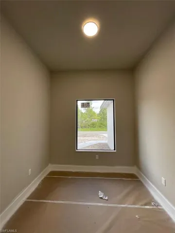 Unfurnished room featuring carpet floors and baseboards