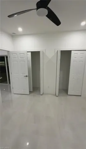 Unfurnished bedroom with multiple closets, recessed lighting, and a ceiling fan