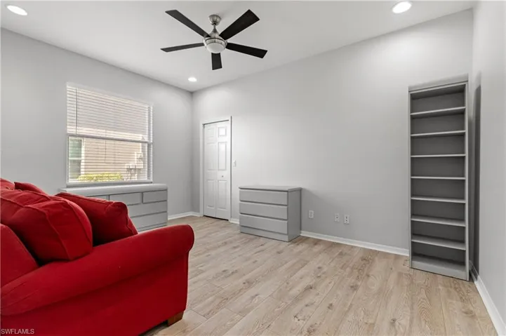 Living area with light wood finished floors, recessed lighting, and ceiling fan