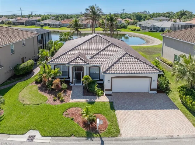 Mediterranean / spanish house featuring an attached garage, a residential view, stucco siding, and driveway
