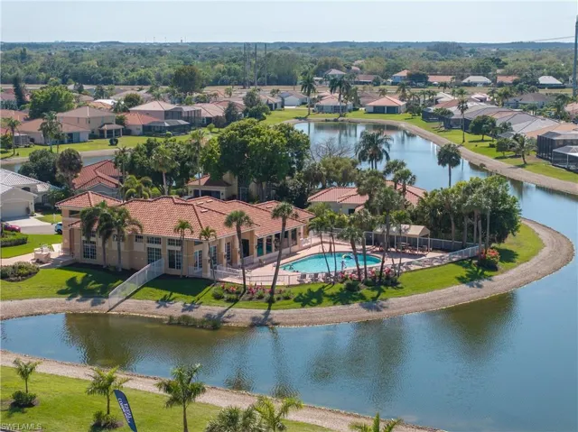 Aerial perspective of suburban area with a large body of water and a pool