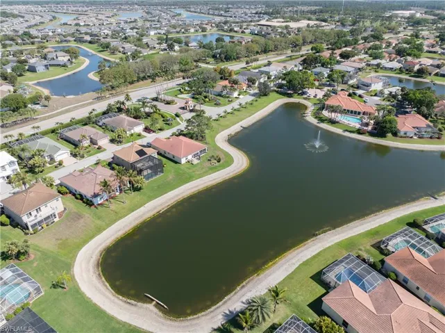 Aerial view of residential area featuring a nearby body of water