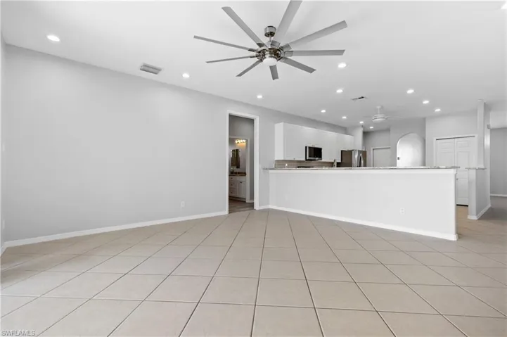 Unfurnished living room with recessed lighting, ceiling fan, and light tile patterned floors