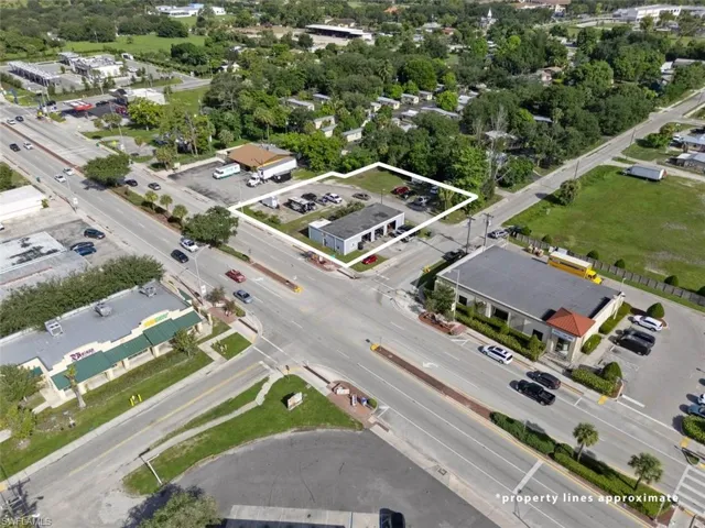 Aerial view of property's location with property parcel outlined and a tree filled landscape