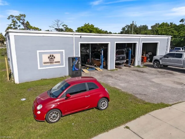 View of parking / parking lot featuring a garage