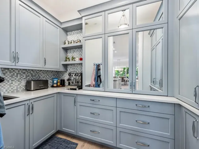 Butler's pantry with sink and concealed storage