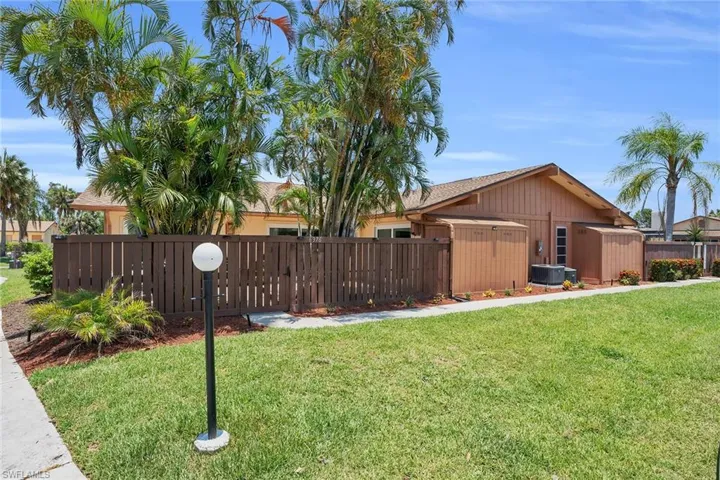 View of yard featuring an outdoor structure and central AC