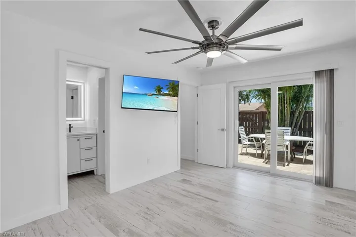 Empty room featuring ceiling fan, light hardwood / wood-style flooring, and sink