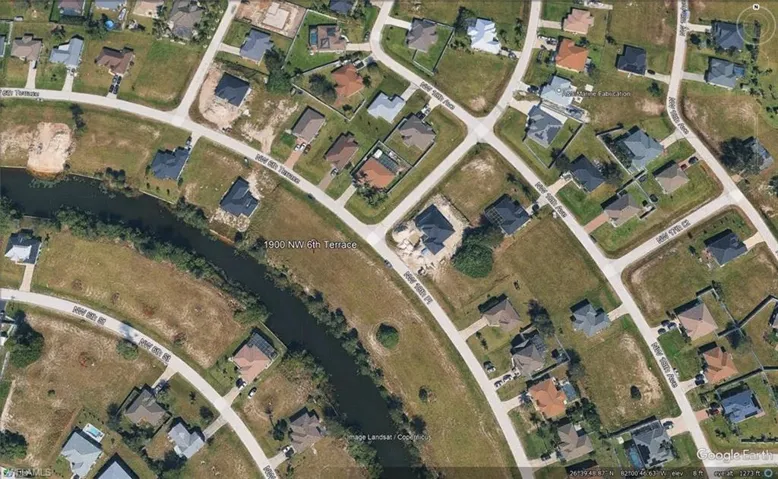 Aerial View of Residential Area. Displaying the property and surrounding structures with street and waterways