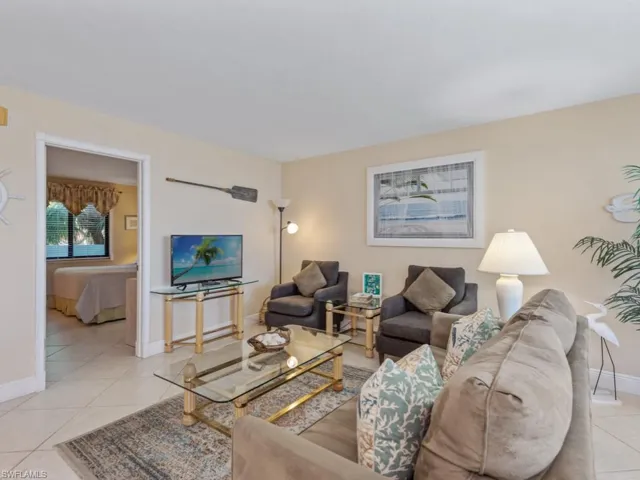 Living room featuring light tile patterned flooring and baseboards
