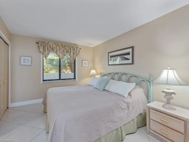 Bedroom with light tile patterned flooring and a closet