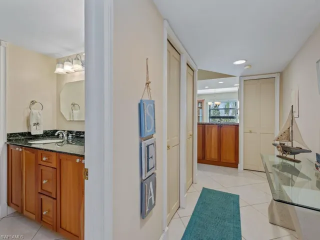 Hallway with light tile patterned flooring and recessed lighting