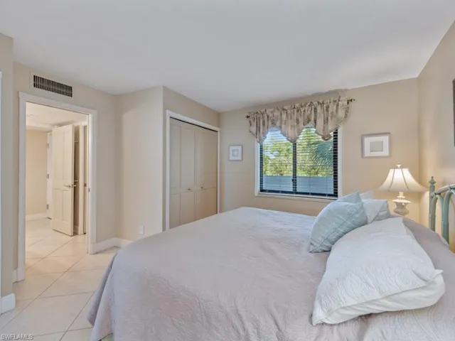 Bedroom featuring light tile patterned floors and a closet