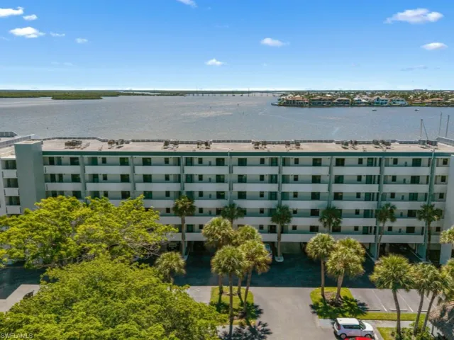View of apartment building / complex featuring a water view