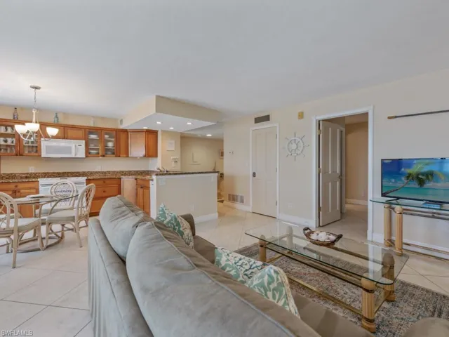 Living room featuring light tile patterned floors, recessed lighting, and a chandelier