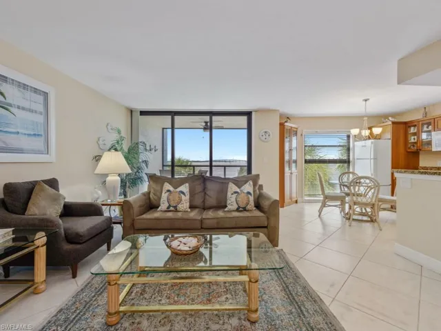 Living area featuring light tile patterned floors, a chandelier, and expansive windows