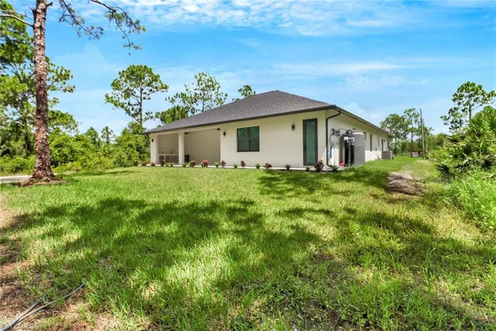 Rear view of house with a lawn