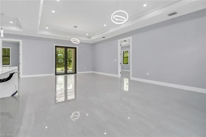 Tiled spare room with a raised ceiling