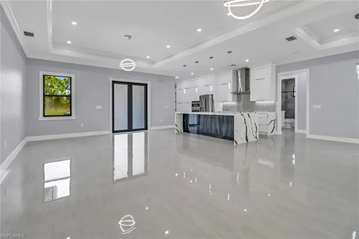 Living room featuring crown molding and a tray ceiling