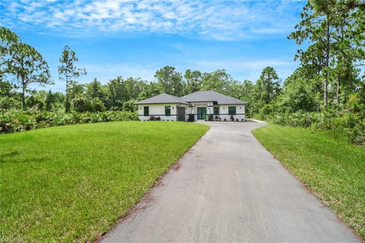 Ranch-style home featuring a front yard