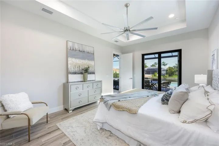 Bedroom featuring access to outside, light hardwood / wood-style flooring, and ceiling fan