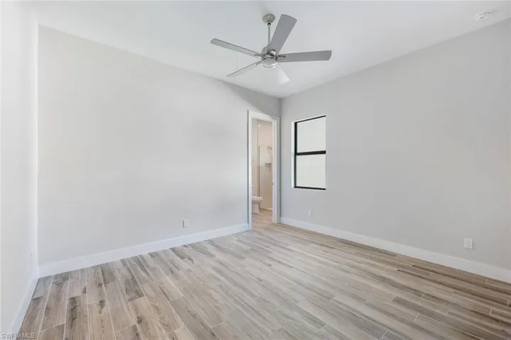 Unfurnished room with light wood-type flooring and ceiling fan