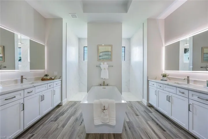 Bathroom with shower with separate bathtub, vanity, and hardwood / wood-style flooring