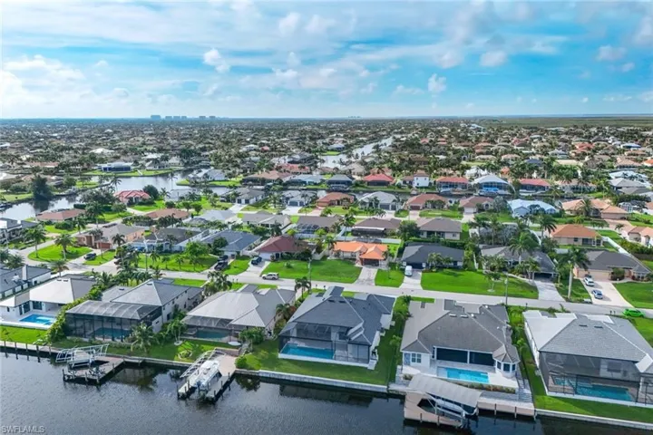 Birds eye view of property with a water view