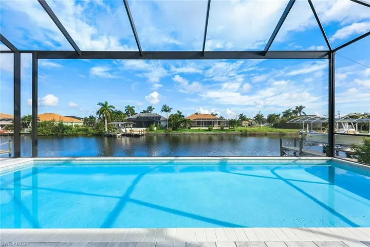 View of swimming pool with a water view and a lanai