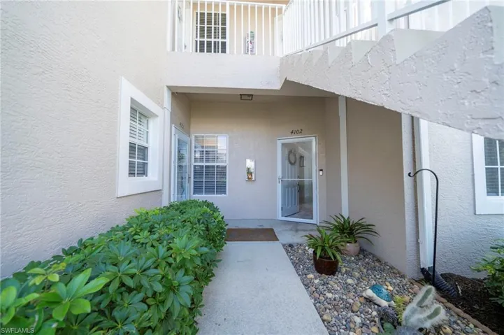 Property entrance with stucco siding