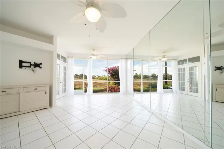 Unfurnished sunroom featuring french doors