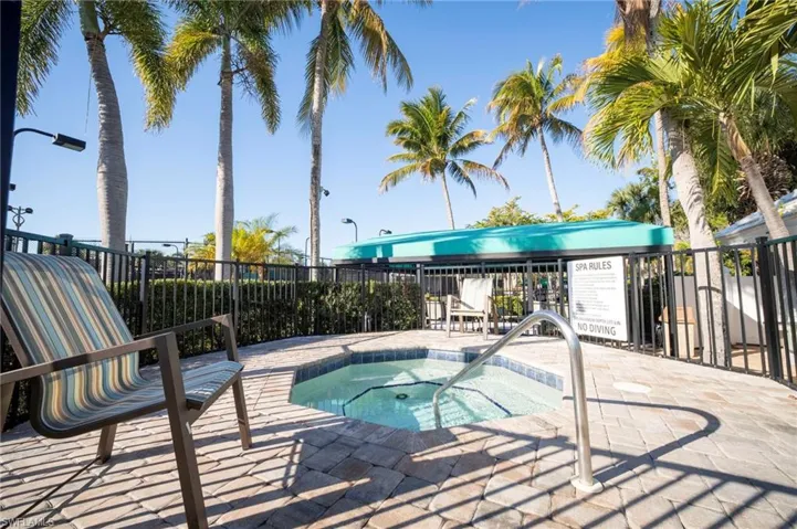 View of pool with a hot tub, a swimming pool, and patio surround