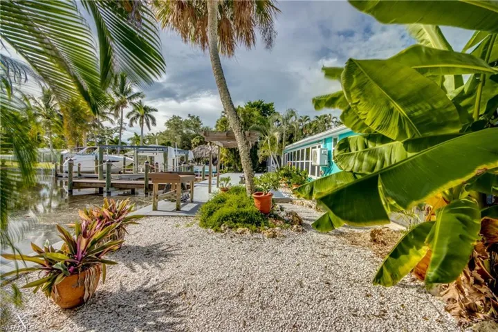 View of yard with boat lift and a dock